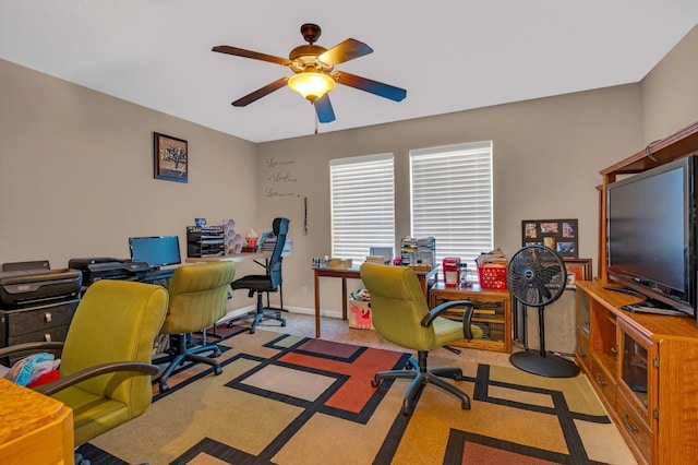 office space featuring light carpet and ceiling fan