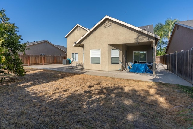 rear view of property featuring a patio and central AC unit