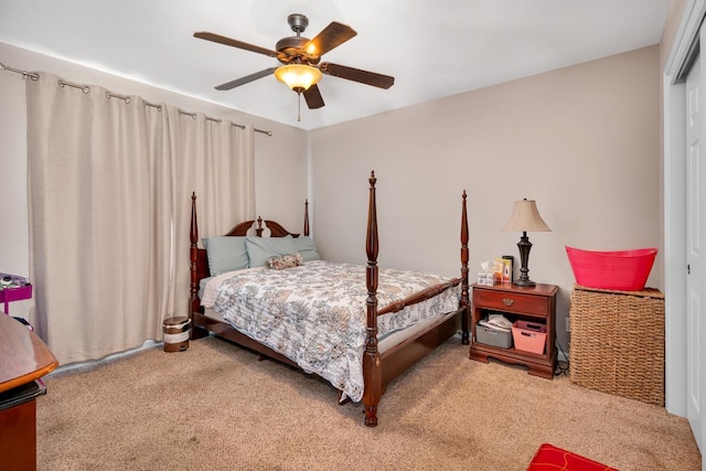 carpeted bedroom with ceiling fan and a closet