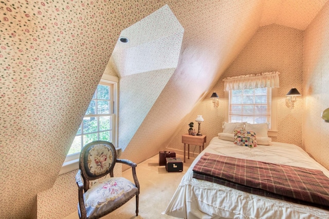 carpeted bedroom featuring wallpapered walls and lofted ceiling