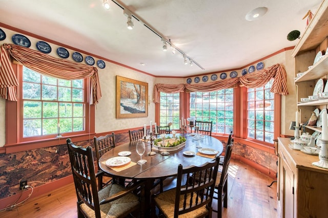 dining area with hardwood / wood-style floors and ornamental molding