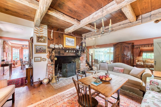 living room with beam ceiling, wood ceiling, and hardwood / wood-style flooring