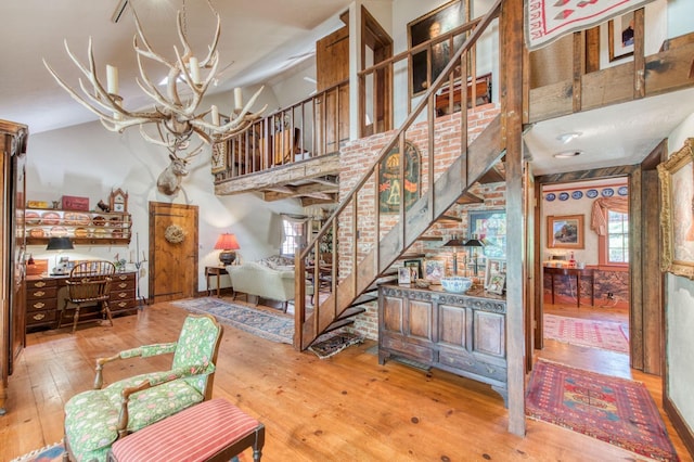 interior space with hardwood / wood-style flooring and a high ceiling