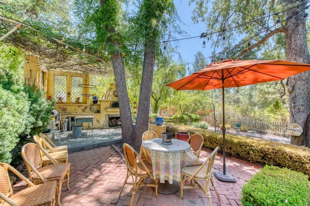 view of patio / terrace featuring outdoor dining area and exterior fireplace