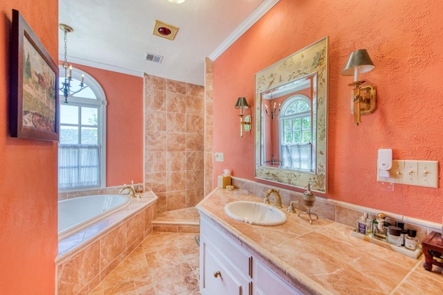 full bathroom with visible vents, a garden tub, ornamental molding, a textured wall, and vanity