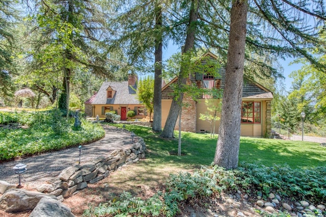 view of front of house featuring crawl space, a chimney, and a front yard