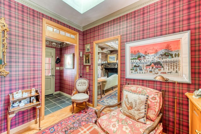 sitting room with wallpapered walls, baseboards, and tile patterned flooring