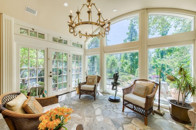 sunroom / solarium with visible vents and a chandelier