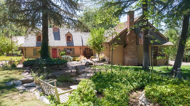 rear view of house featuring a chimney