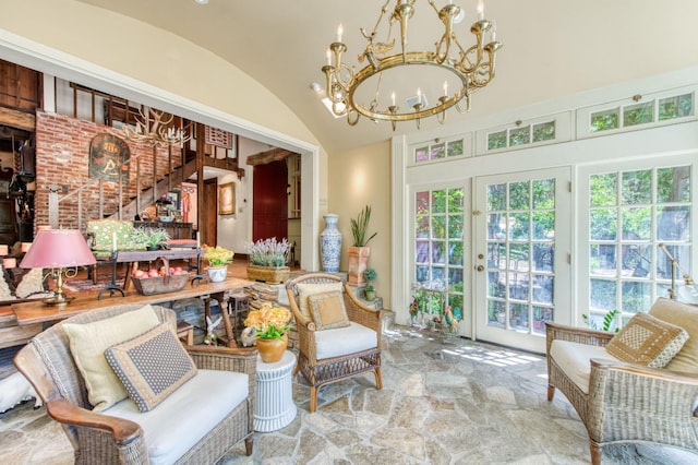 sunroom / solarium featuring a chandelier and lofted ceiling