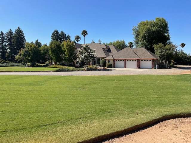 view of front of house featuring a garage and a front lawn