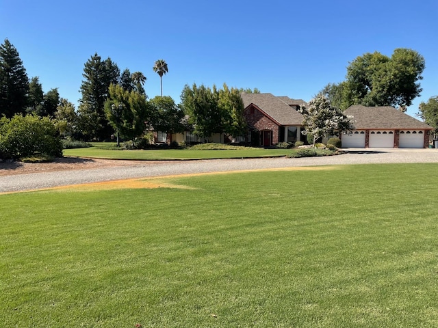 exterior space featuring a front lawn and a garage