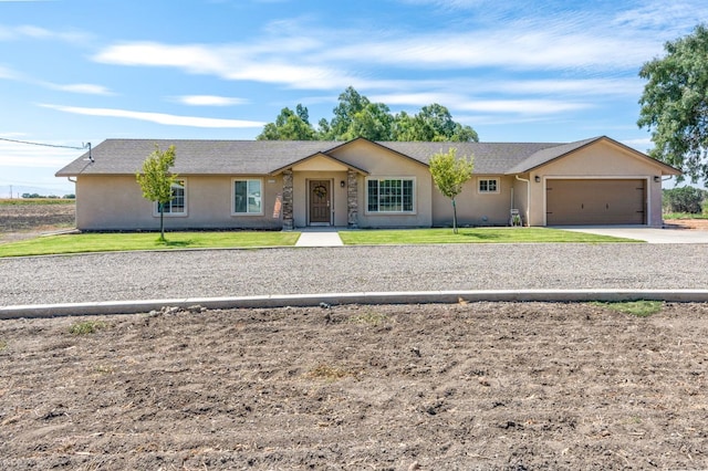 ranch-style house with a front yard and a garage