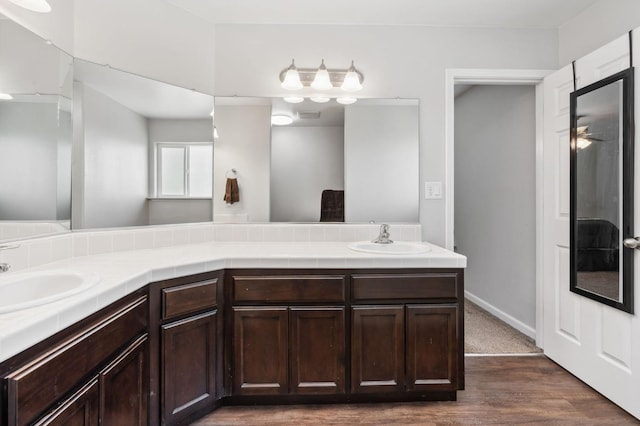 bathroom featuring vanity, ceiling fan, and hardwood / wood-style flooring