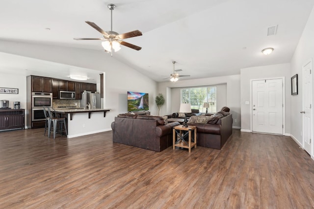 living room featuring dark wood-type flooring, vaulted ceiling, and ceiling fan