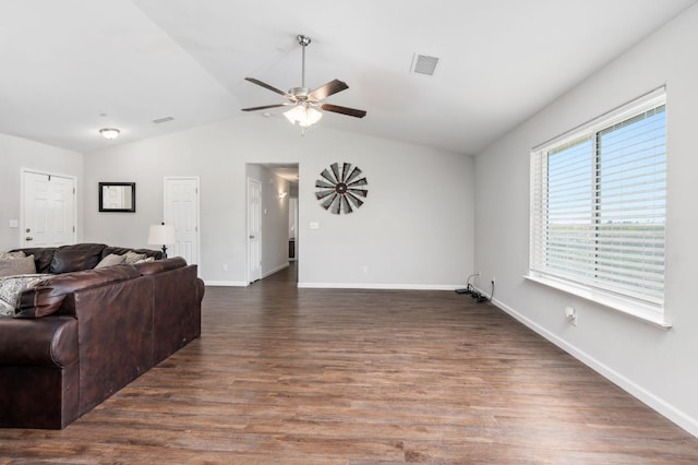 living room featuring dark hardwood / wood-style floors, ceiling fan, and vaulted ceiling