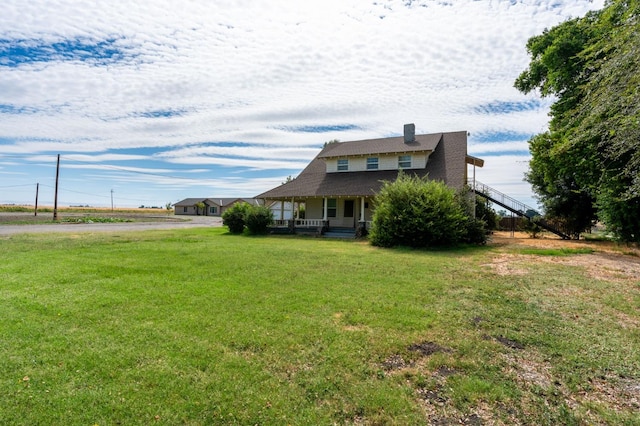 view of front of house with a front yard and a porch