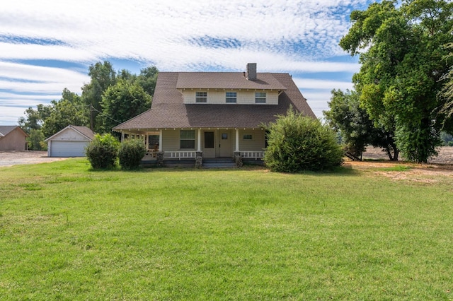 view of front of house with an outdoor structure, a garage, a front lawn, and a porch