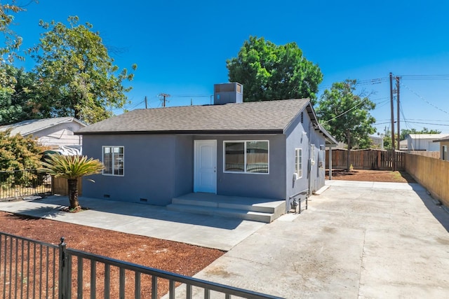 1845 N 10th Ave, Hanford, CA 93230 - bungalow with a shingled roof, stucco siding, a fenced backyard, a patio area, and a chimney