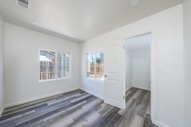 unfurnished room featuring dark wood-type flooring