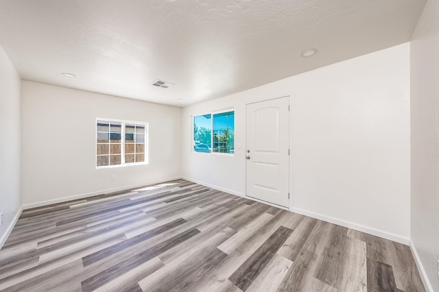 unfurnished room featuring light hardwood / wood-style floors