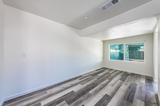 empty room with hardwood / wood-style floors