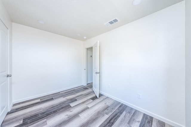 spare room with hardwood / wood-style floors