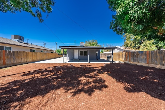 back of house with central AC unit and a patio