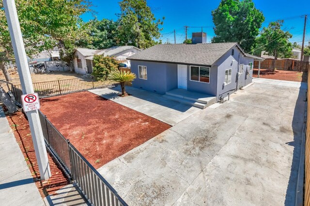 1845 N 10th Ave, Hanford, CA 93230 - view of front of house featuring a shingled roof and stucco siding
