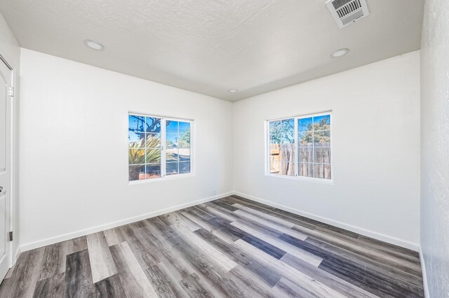 1845 N 10th Ave, Hanford, CA 93230 - spare room featuring healthy amount of natural light, wood finished floors, baseboards, and recessed lighting
