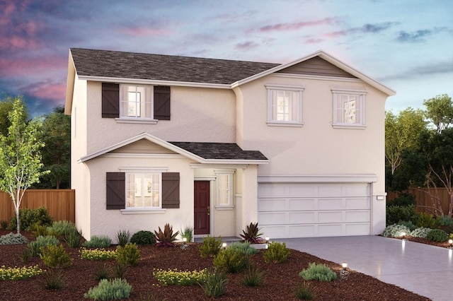 traditional-style home with stucco siding, fence, concrete driveway, an attached garage, and a shingled roof