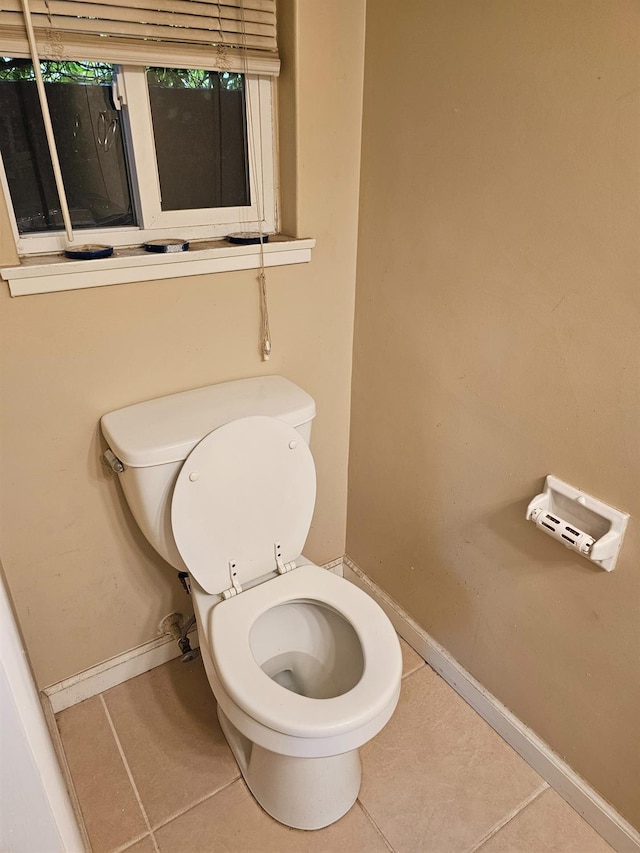 bathroom with tile patterned flooring and toilet