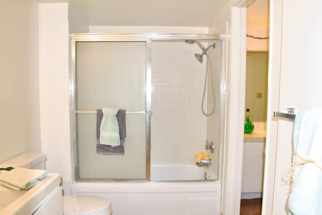 full bathroom featuring shower / bath combination with glass door, vanity, and toilet