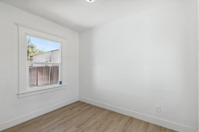 unfurnished room with hardwood / wood-style flooring