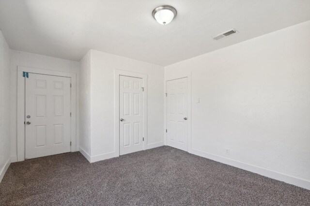 unfurnished bedroom featuring carpet floors and a closet