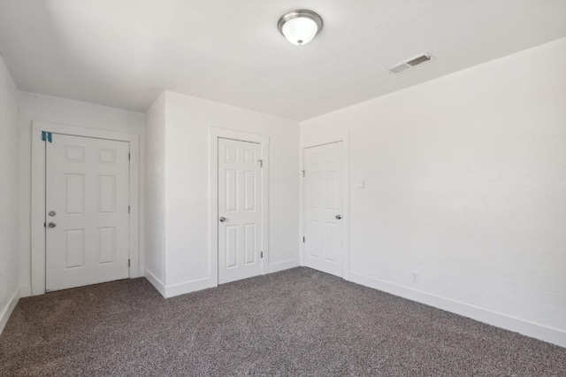 unfurnished bedroom featuring dark colored carpet