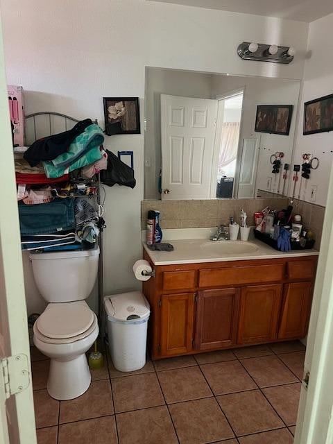 bathroom featuring tile patterned flooring, vanity, and toilet