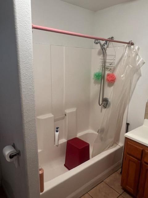 bathroom featuring tile patterned floors, bathtub / shower combination, and vanity