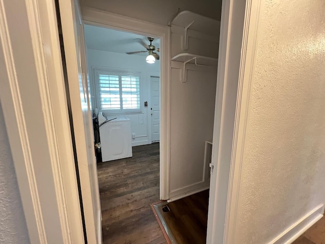 corridor with dark wood-type flooring and washer / dryer