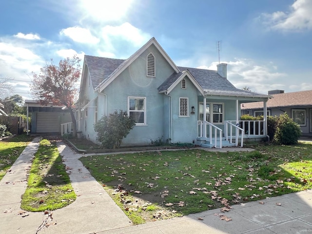 bungalow-style house featuring covered porch and a front yard