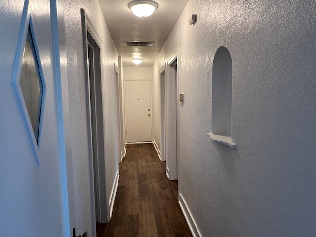 hall with dark wood-type flooring