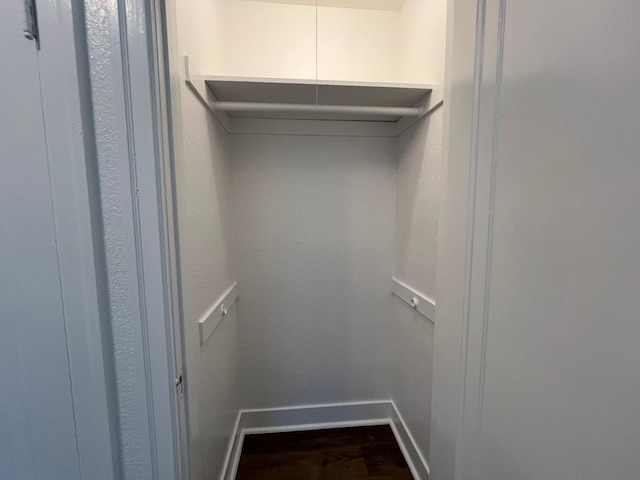 walk in closet featuring dark hardwood / wood-style flooring