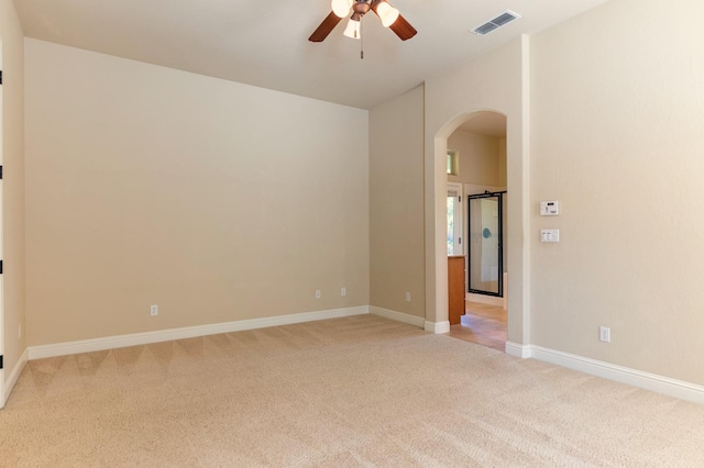 empty room featuring light colored carpet and ceiling fan