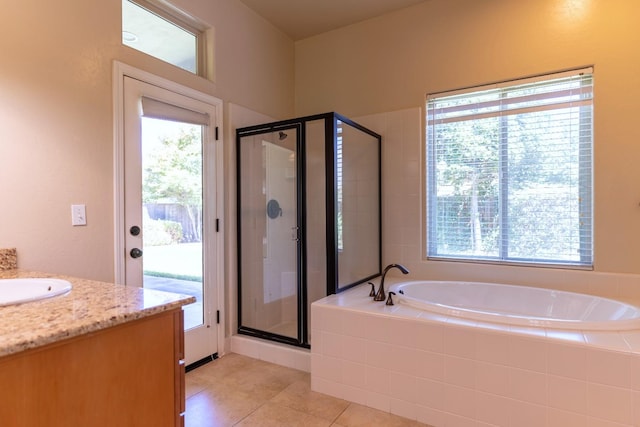 bathroom featuring a wealth of natural light, separate shower and tub, tile patterned flooring, and vanity