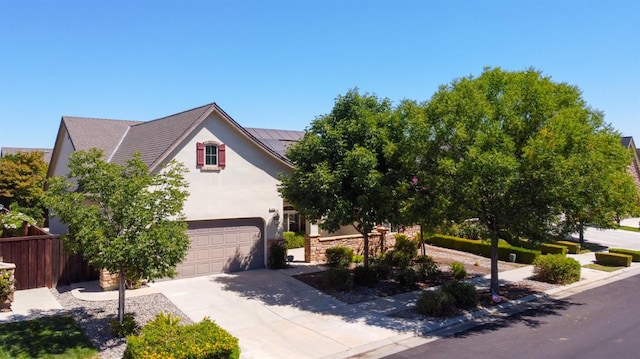 view of property hidden behind natural elements with a garage