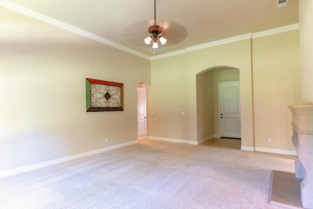 spare room featuring ceiling fan, ornamental molding, and light colored carpet