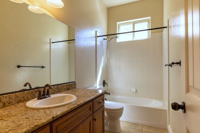 full bathroom featuring tiled shower / bath combo, tile patterned flooring, toilet, and vanity