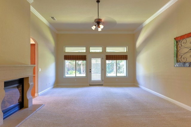 unfurnished living room featuring light colored carpet, crown molding, and ceiling fan