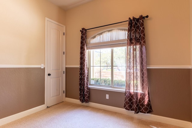 unfurnished room with light colored carpet