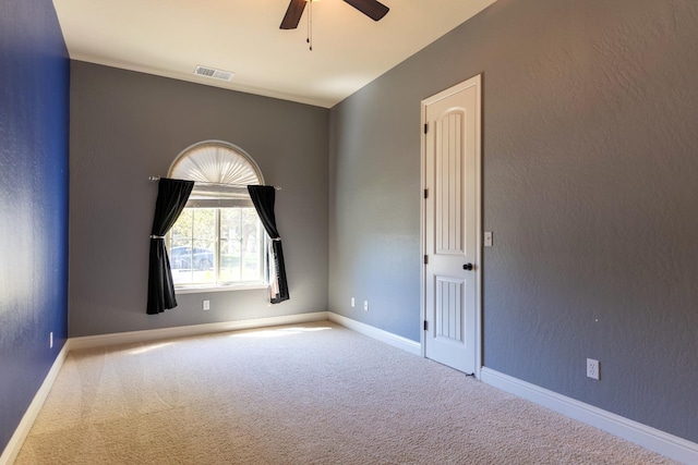 unfurnished room featuring ceiling fan and carpet flooring